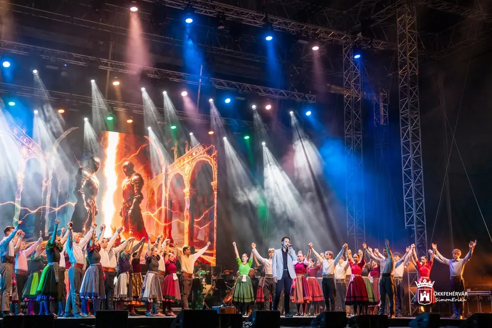 The full company in the finale, with the lit basilica space behind